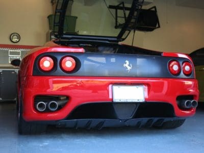 Red sports car in garage setting.