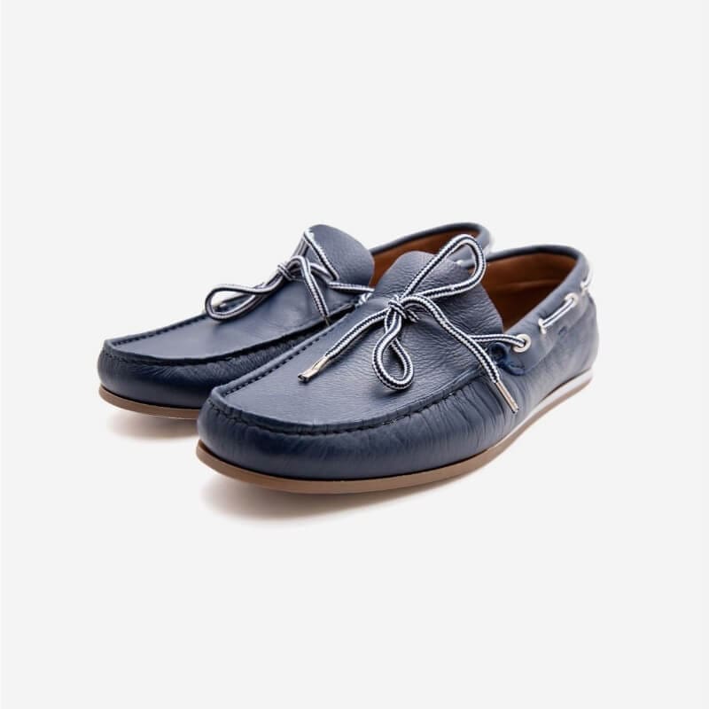 Navy blue leather boat shoes with laces.