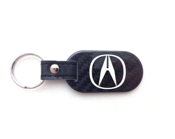 Keychain with logo on a black background.