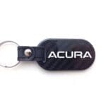 Acura keychain with leather and carbon design.