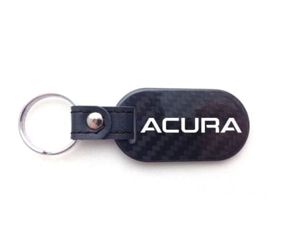 Acura keychain with leather and carbon design.