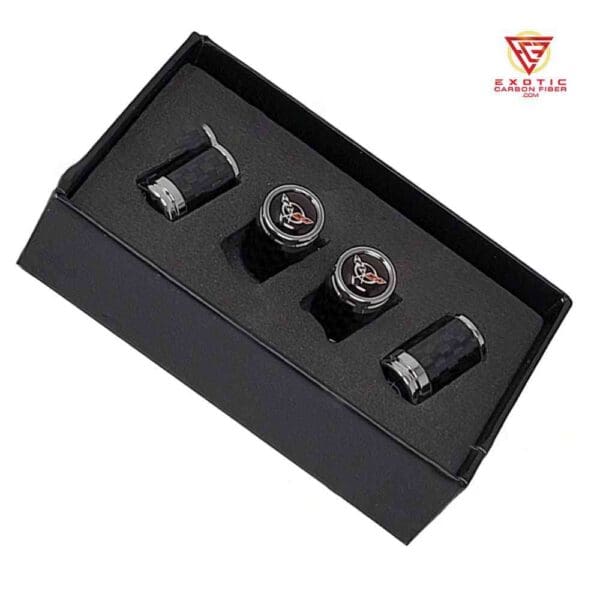 Carbon fiber valve stem caps in a box.