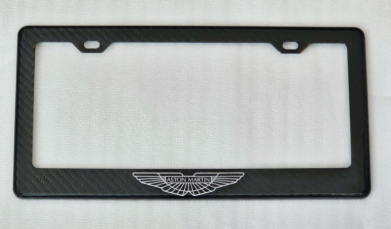 Black license plate frame with Aston Martin logo in white.