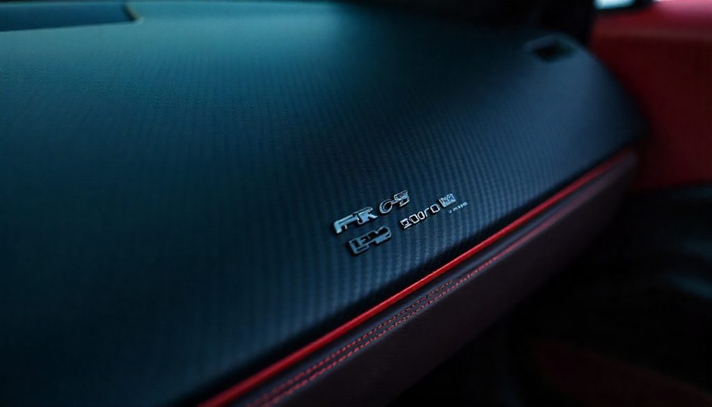 Close-up of rare 2K carbon fiber weave on a handcrafted luxury car interior panel in a high-end exotic vehicle