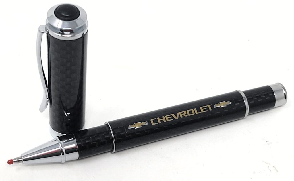 A sleek black pen with a carbon fiber texture and Chevrolet branding.